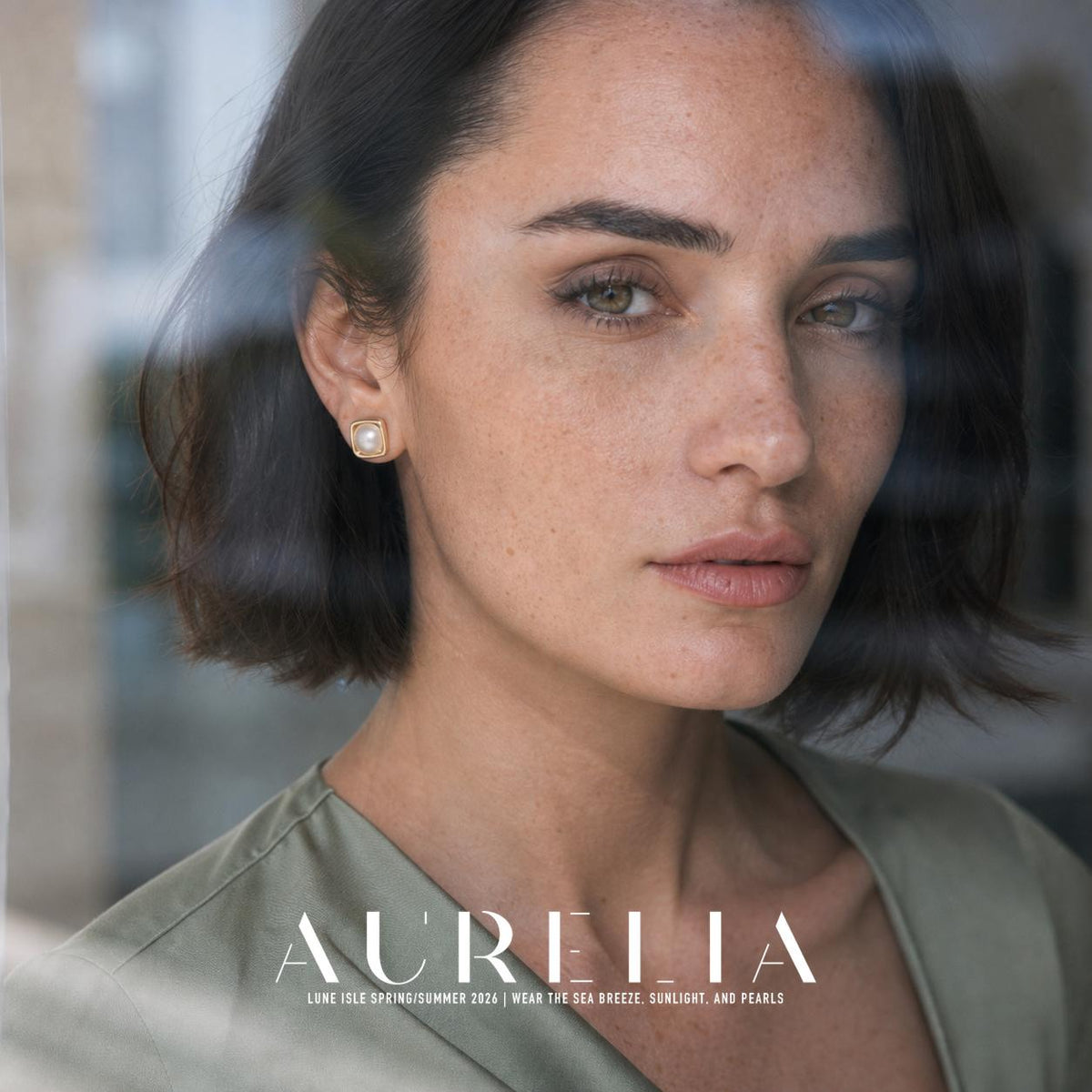 Portrait through glass; the square stud remains clear. Rounded square gold-colored layered frame around one round white center; the same square frame and center are visible in every worn view.