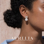 Close view of a four-petal clear-accent cluster above a round white pearl-like bead, with gold-tone details.