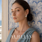 Head-and-shoulders portrait in a blue-gray dress against patterned tiles, with the tail earring clearly visible.