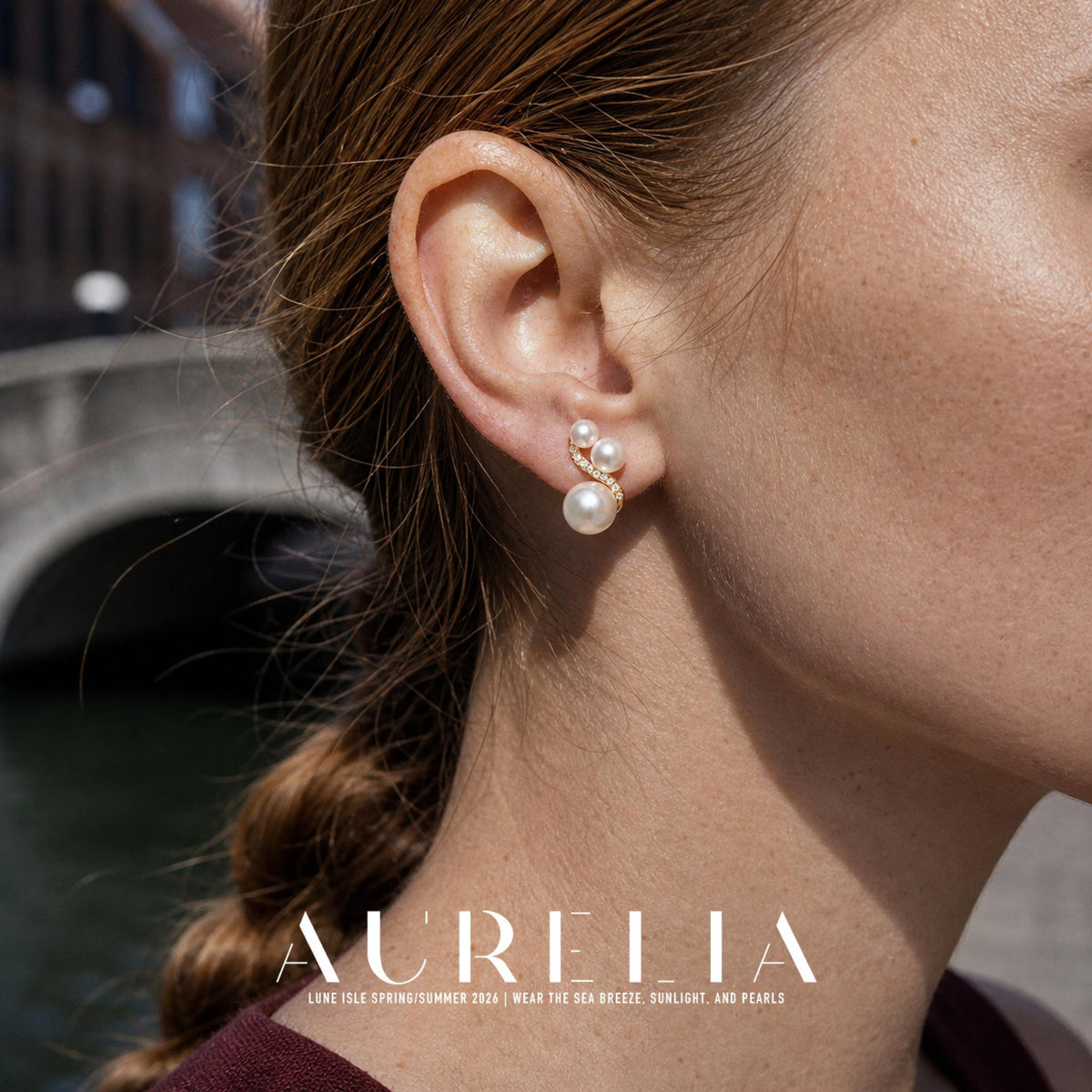 Close ear view showing the three white beads and curved stone-set gold-tone strip.