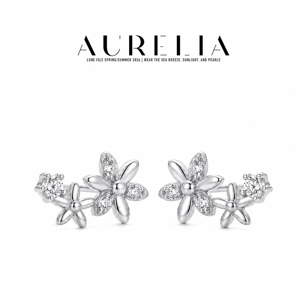 Silver-tone standalone pair retains the large alternating clear/polished-petal flower, smaller flower and round accent.
