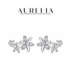 Silver-tone standalone pair retains the large alternating clear/polished-petal flower, smaller flower and round accent.
