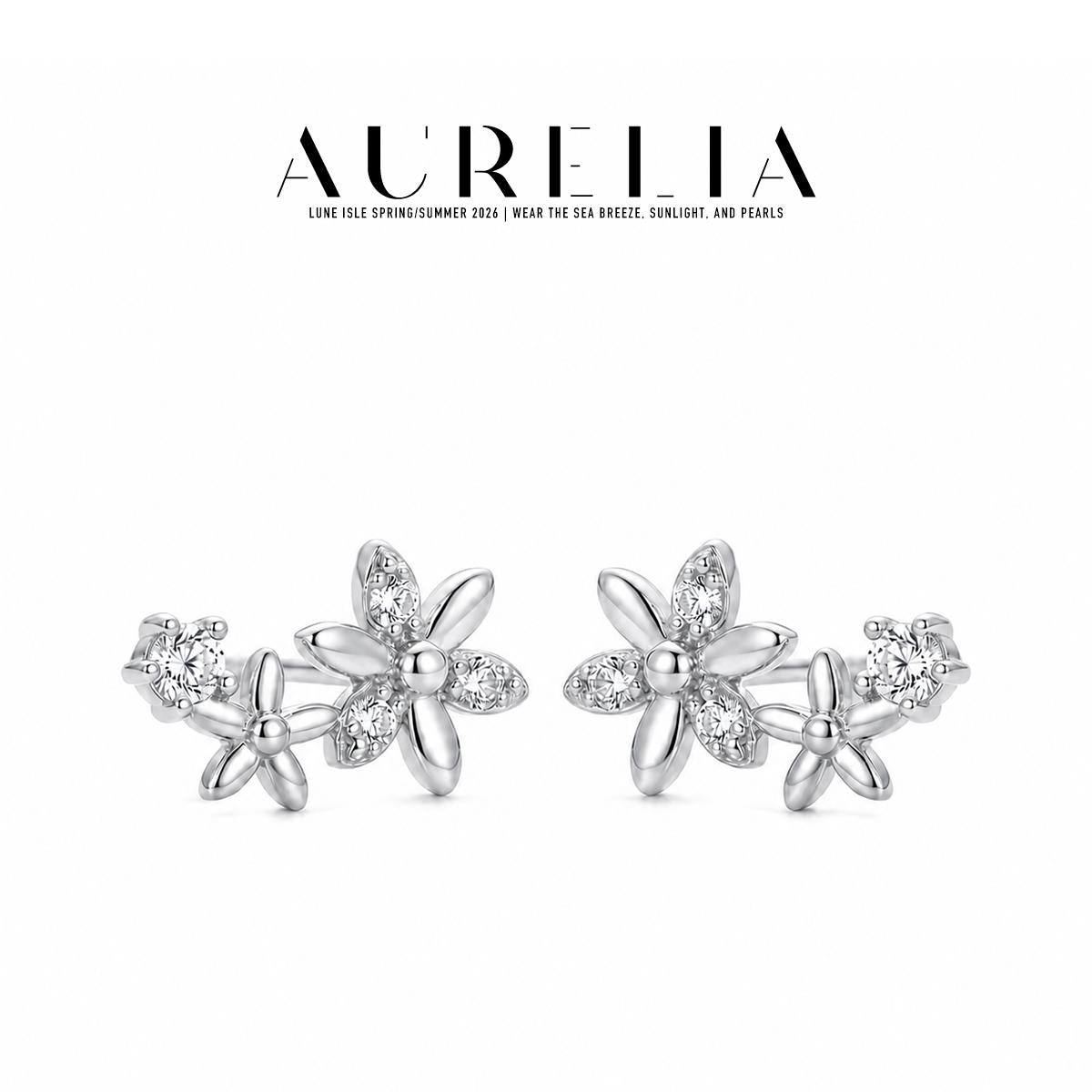 Silver-tone standalone pair retains the large alternating clear/polished-petal flower, smaller flower and round accent.
