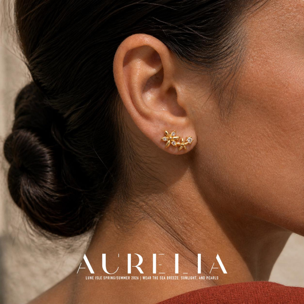 Close ear view clearly showing the two-flower cluster and round clear accent.