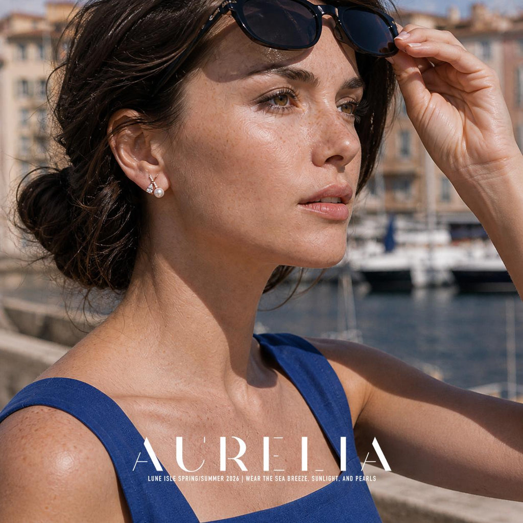 Portrait with sunglasses raised, showing crossed narrow bars, pear-shaped accent and white round bead.