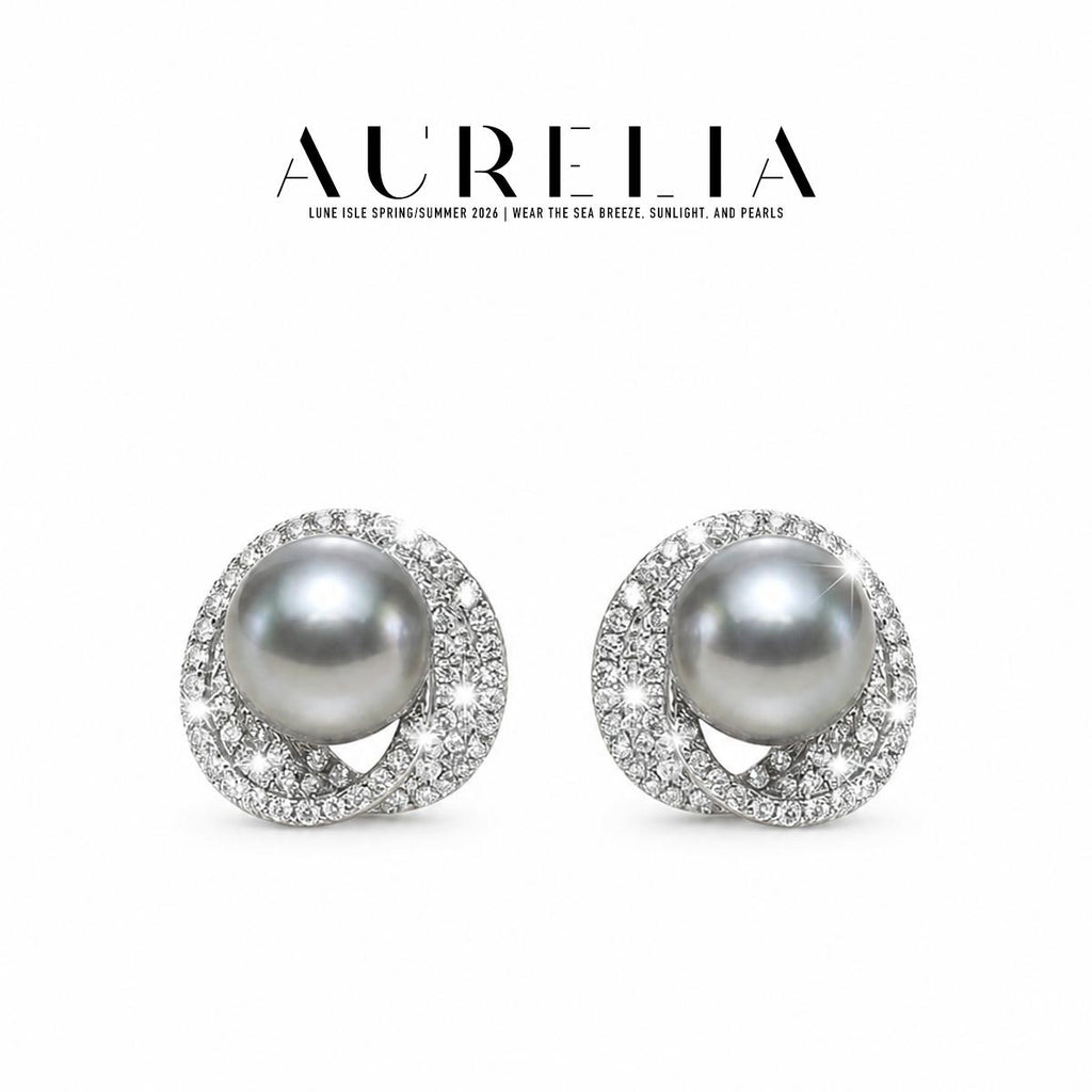 Front-facing pair of silver-colored studs on white, with dark gray round centers inside overlapping clear-studded loops.