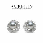 Front-facing pair of silver-colored studs on white, with dark gray round centers inside overlapping clear-studded loops.