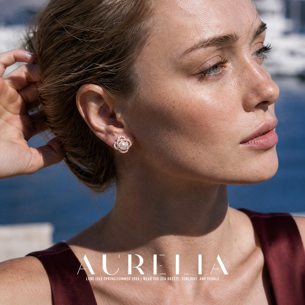 Close portrait with hand in hair showing warm-tone four-lobed floral stud.