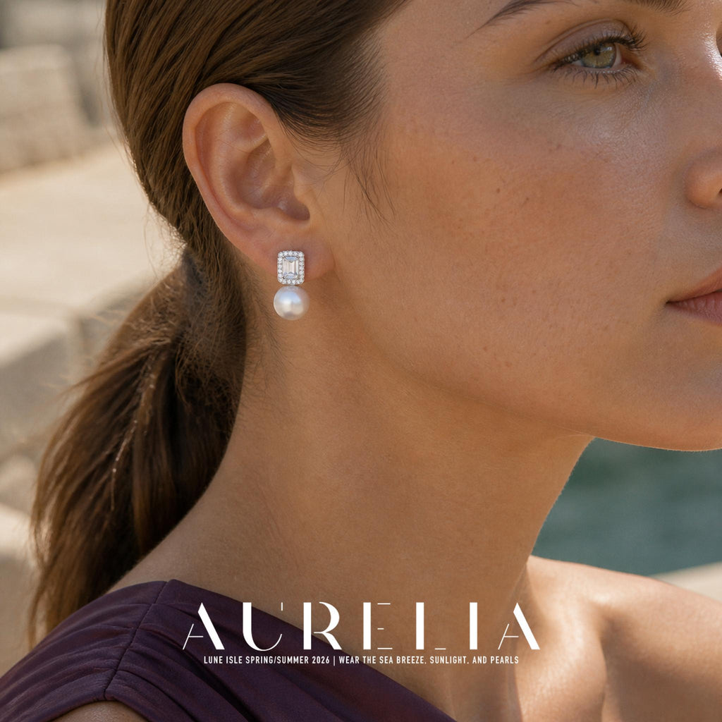 Close view of a rectangular halo-shaped top and single white round bead worn on an ear.