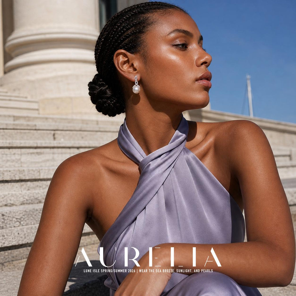 Seated profile by a column adds side wearing context for the stacked-loop and bead design.
