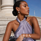 Seated profile by a column adds side wearing context for the stacked-loop and bead design.