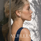 Side-profile portrait beside reflective glass shows unequal white beads and the small bright third-point cluster.