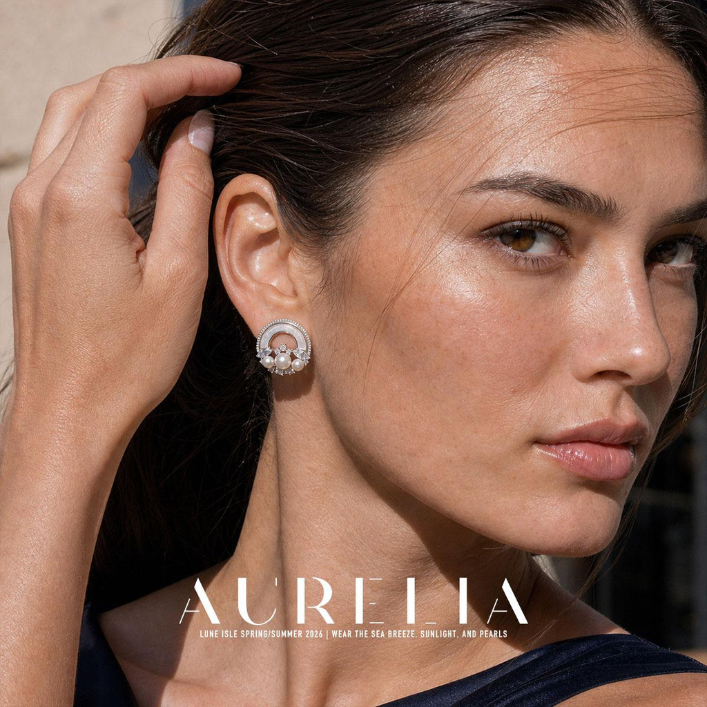 Portrait with the model lifting her hair, exposing the circular earring and its lower bead garland.