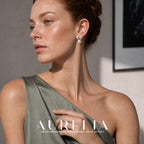Chest-up portrait in green with hand at neckline clearly shows the scalloped pointed butterfly-wing top and white bead.