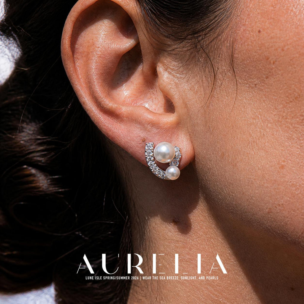 Ear close-up of the curved setting and two different-sized white beads.