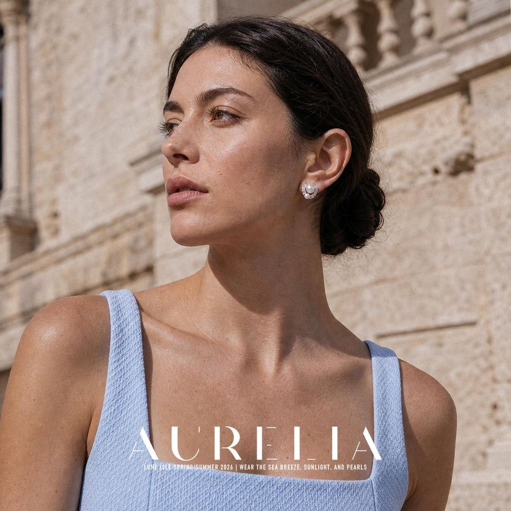 Chest-up portrait in pale blue wearing the matching curved two-bead stud.