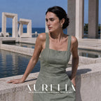 Model in a green dress beside a reflecting pool with the garland earring visible.