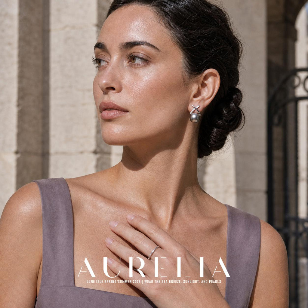 Portrait with hand at neckline, wearing crossed bars over gray bead.