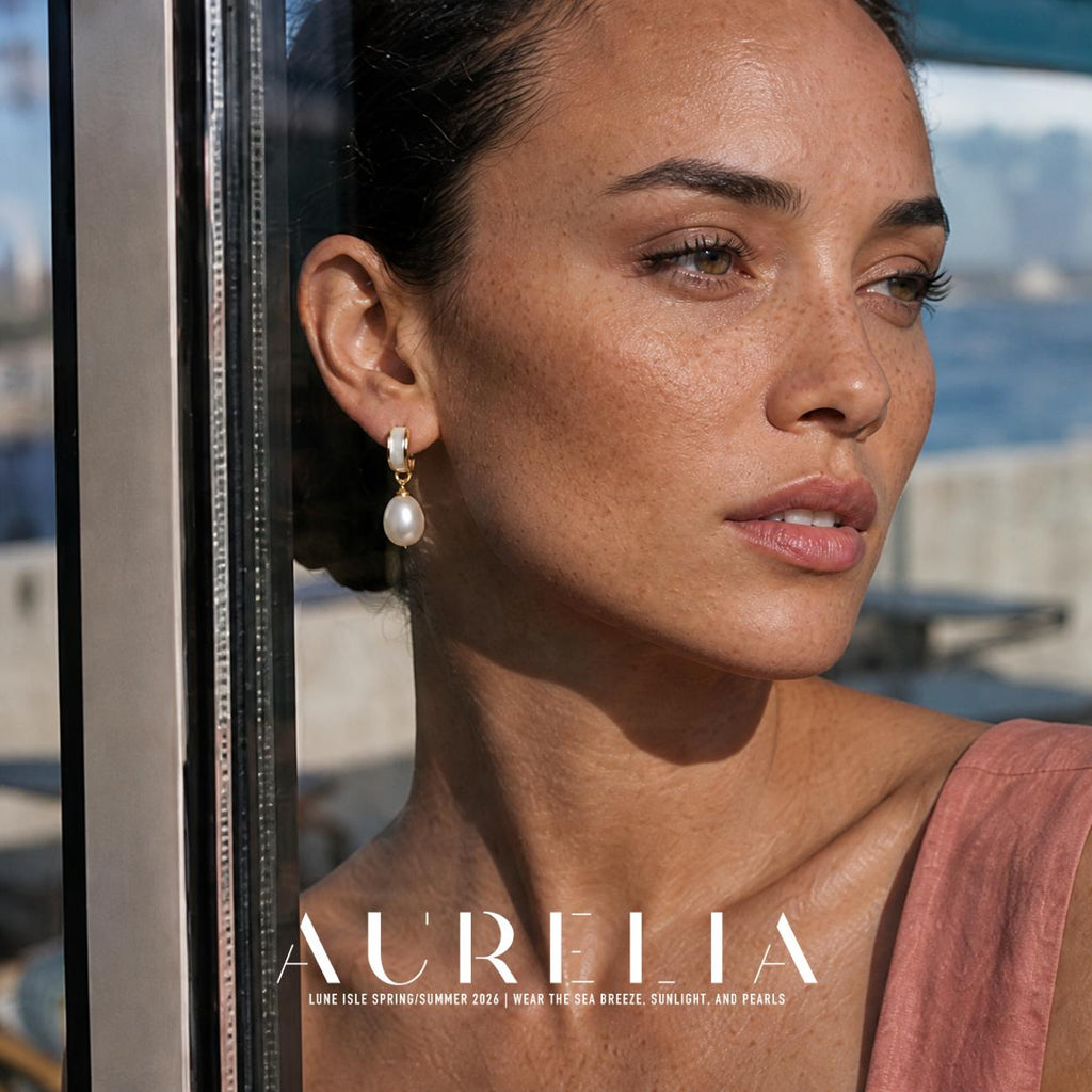 Close portrait beside a window clearly showing matching pale inset hoop, small connector rings and oval white drop.