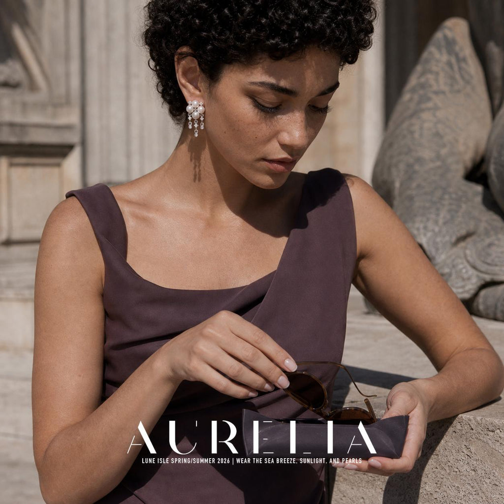 Downward-looking portrait handling sunglasses, with the cluster tassel earring exposed.