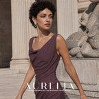 Three-quarter portrait in a plum dress with the matching clustered tassel earring visible.