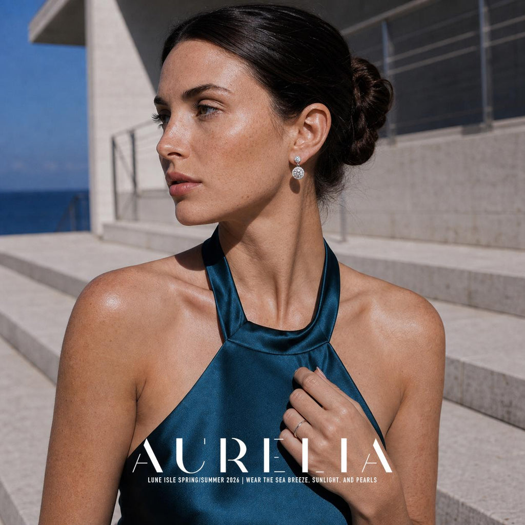 Wider portrait with hand at halter neckline showing round double-drop earrings.