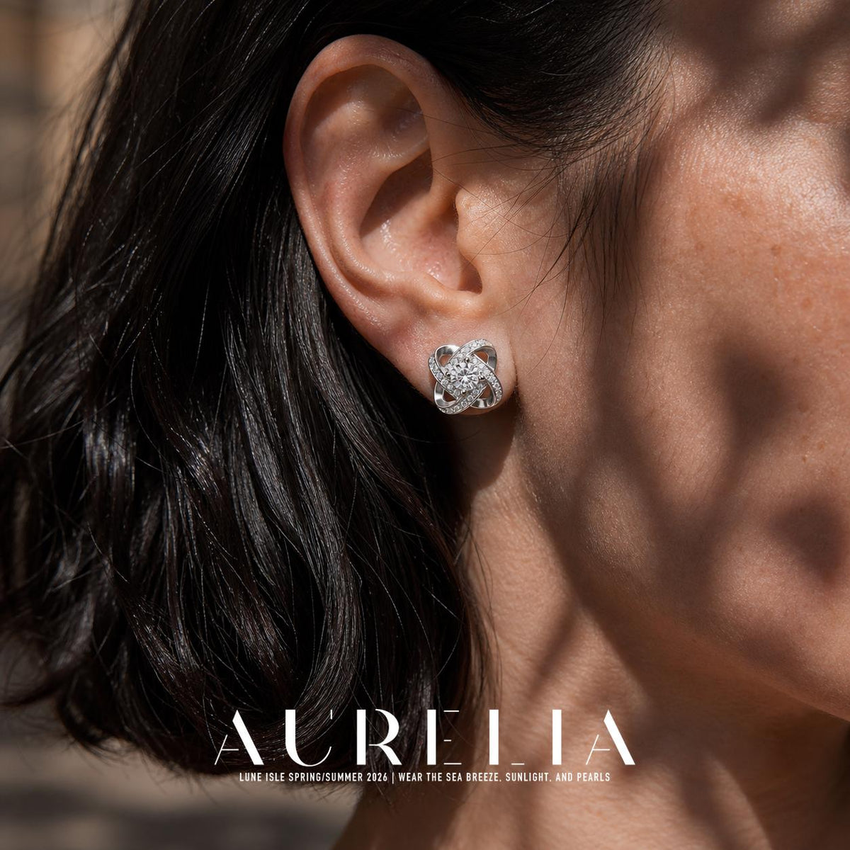 Close ear view of the interlaced loop stud and its central round clear stone.