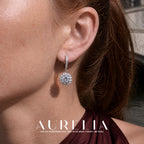 Close ear view showing the hoop and dangling sunflower-shaped clear-stone motif.