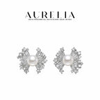 Studio pair in silver tone with round center beads and fan-shaped bow wings tipped with clear stones.