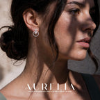 Close profile with the silver-tone circular stud clearly shown on the ear.