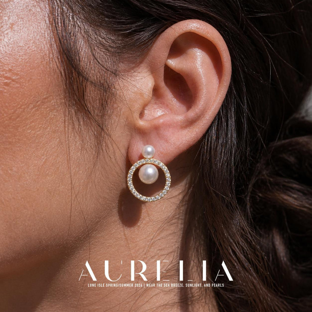 Close ear view of the gold-tone open-circle design with two white beads.