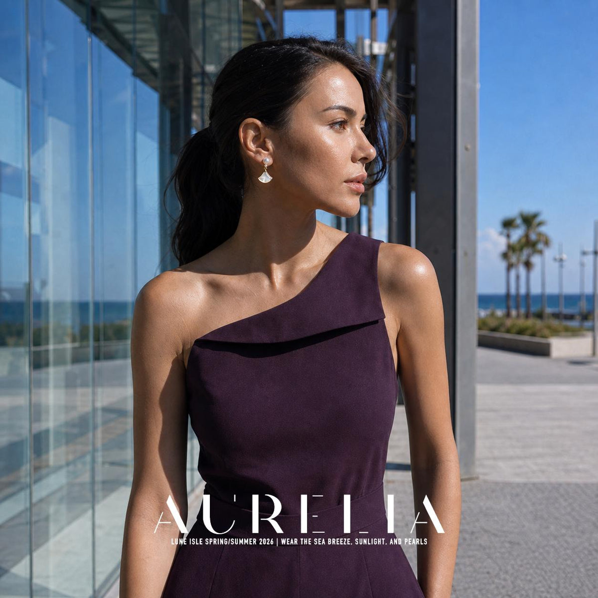 Wider standing portrait in a purple one-shoulder dress beside glass architecture, showing the same bead-and-fan silhouette.