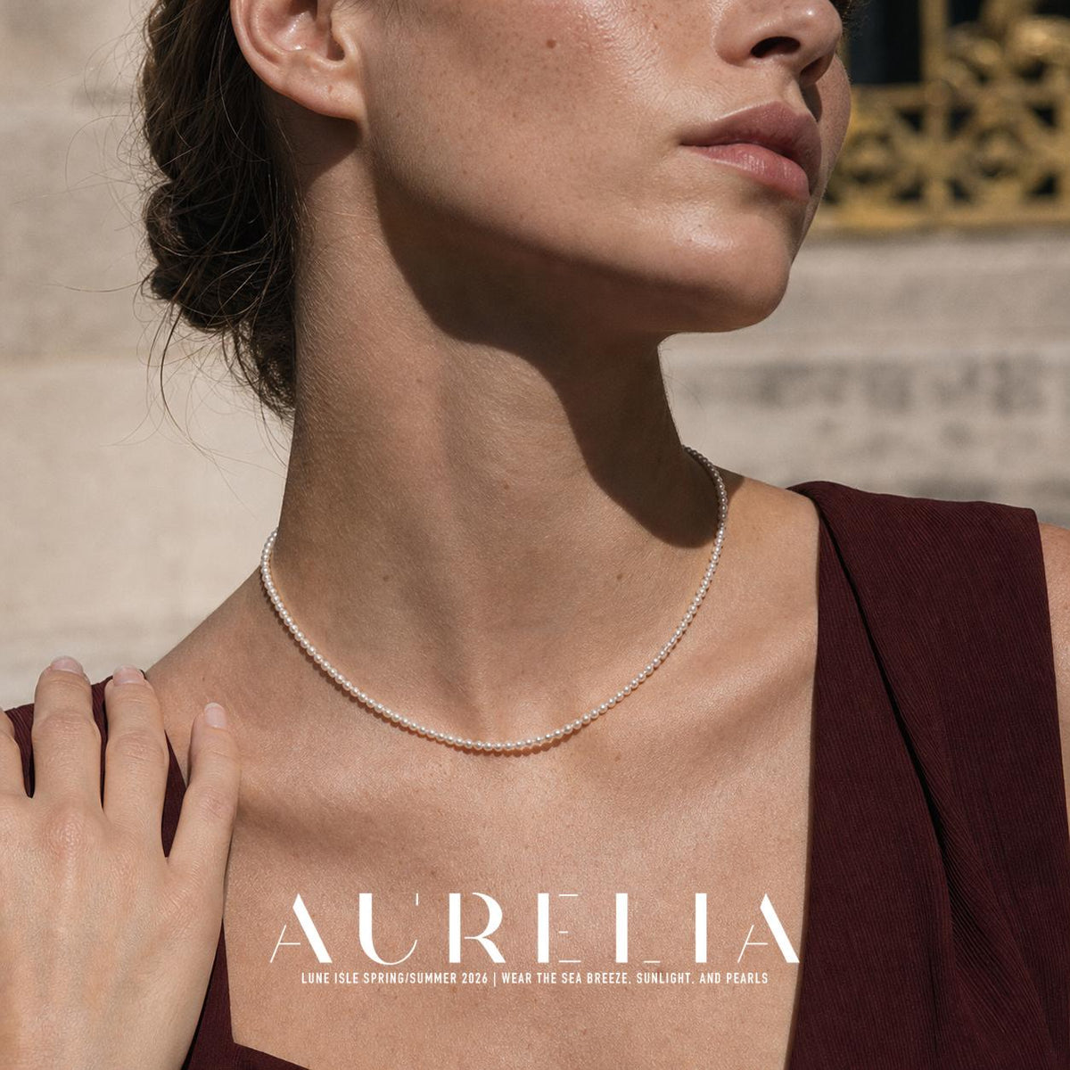 Close neck crop with hand at shoulder clearly displays the uninterrupted bead strand.