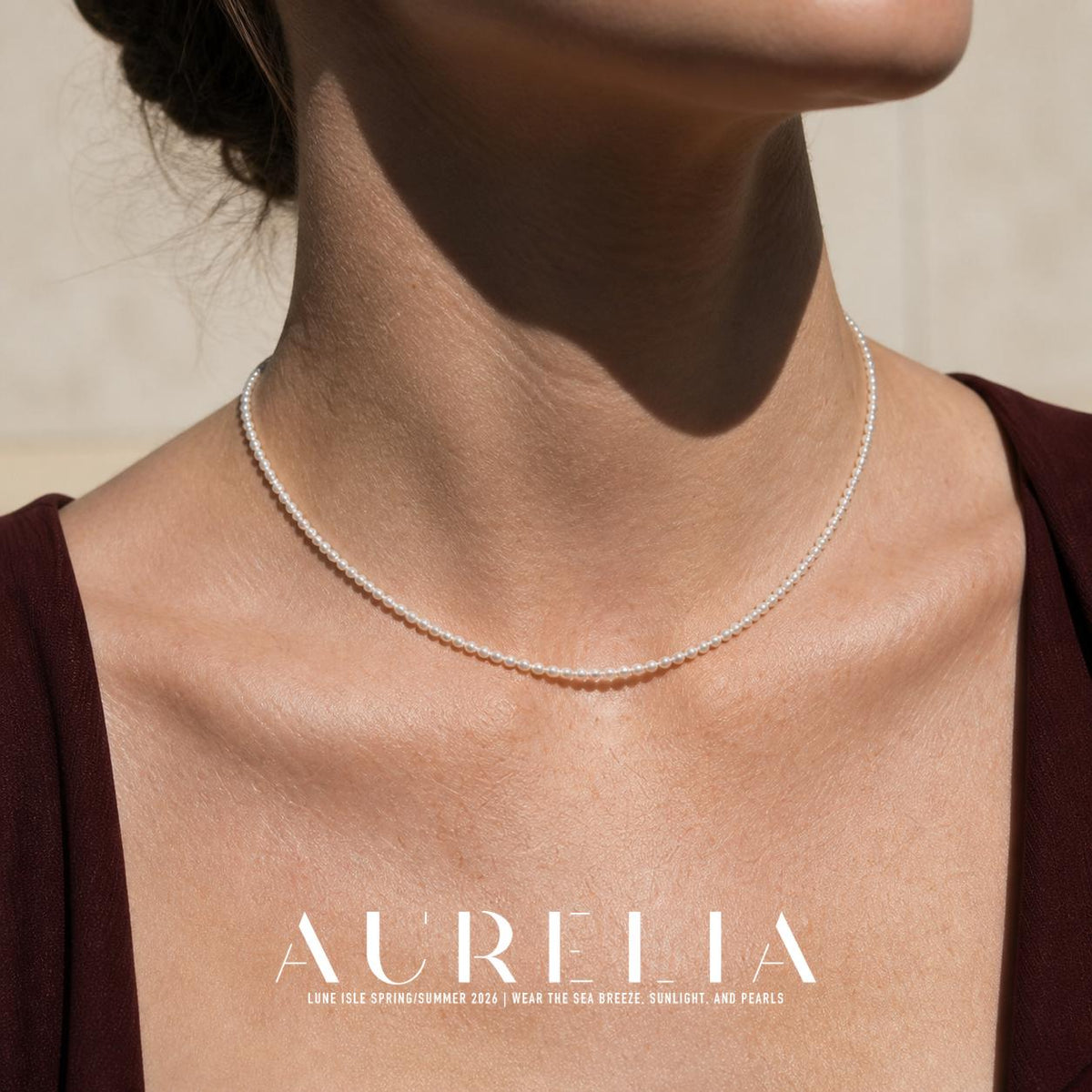 Close neck view of a continuous single strand of small, round, pale beads.