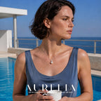 Poolside portrait holding a cup. Fine silver-colored chain joins a single clear accent above one white round pendant; all worn views retain the same small accent and round-drop order.