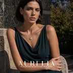 Seated garden portrait in dark green with gold-tone crescent pendant centered on the chest.