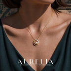 Close neckline view showing the crescent, curved stone row and central white bead.