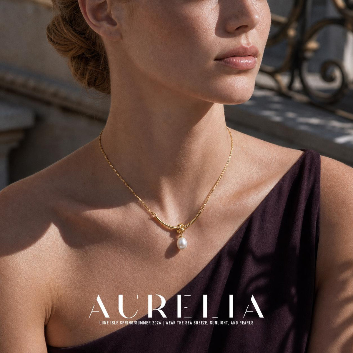 Tighter neckline framing shows the curved connector, knot, chain links and oval white drop.