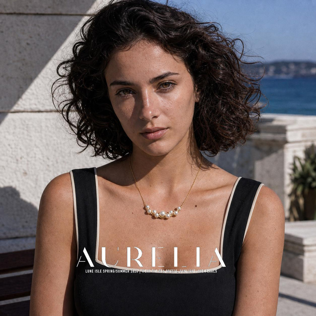 Closer front portrait wearing the matching curved nine-bead cluster necklace.