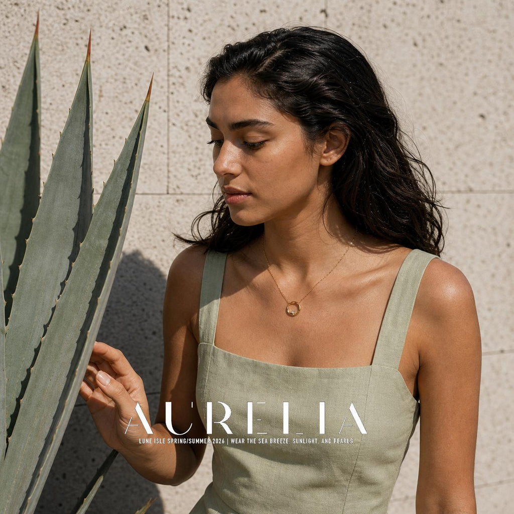 Model beside agave wearing gold-tone circle pendant.