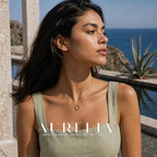 Side-looking seaside portrait with gold-tone open circle pendant.
