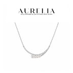 Standalone silver-colored necklace with two clear-accent curved bars and four graduated white beads.