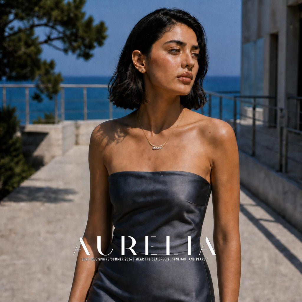 Outdoor model portrait in a dark strapless dress showing the same four-bead curved necklace.