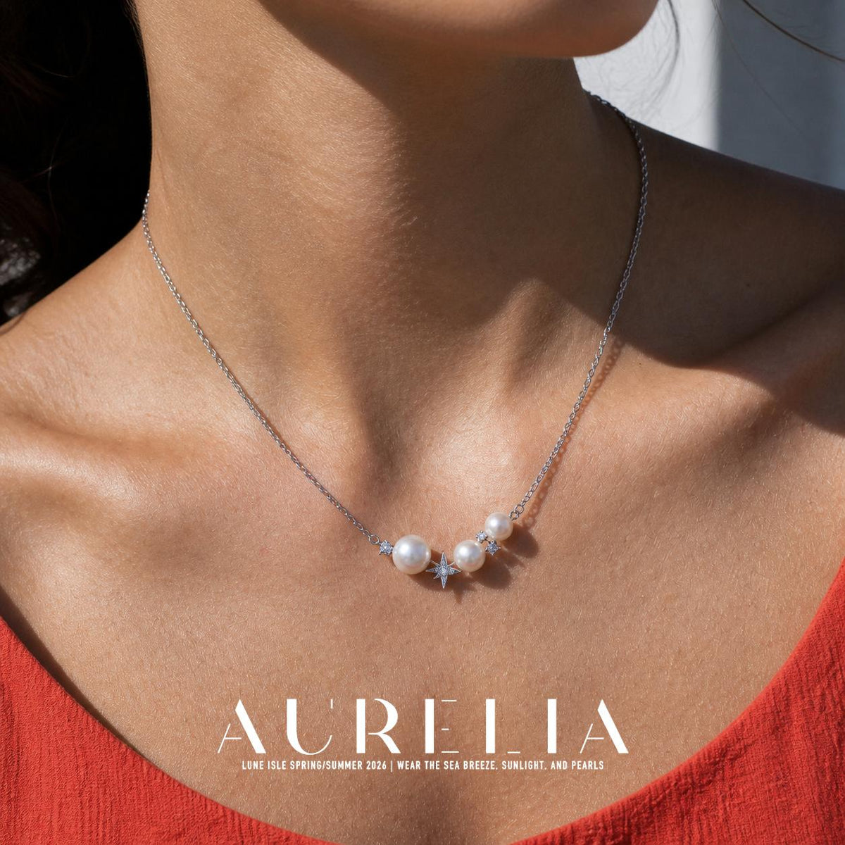 Close chest view clearly showing three unequal white beads, pointed central star and small clear accents.