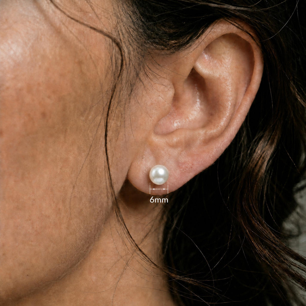 Close ear image showing the matching white round stud with only a 6mm measurement label.