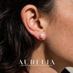 Ear close-up of a simple pink round stud.