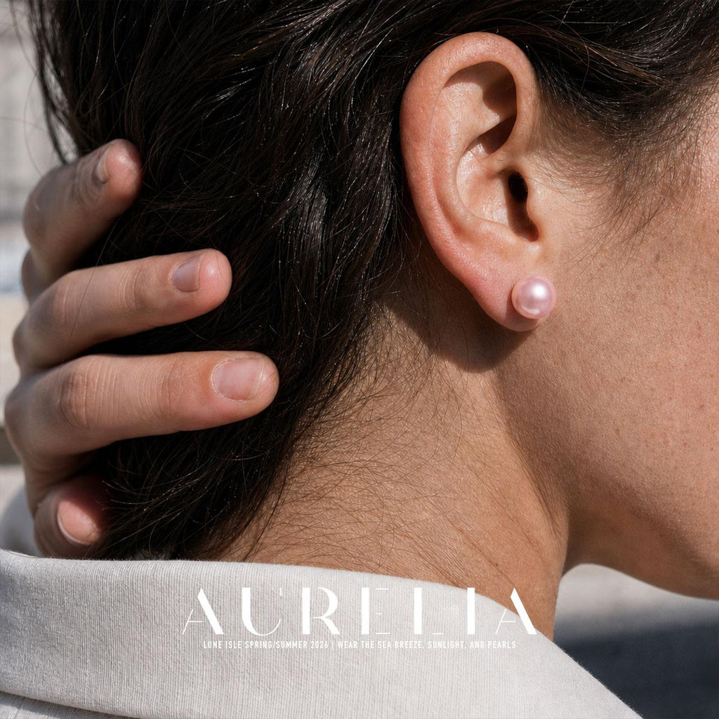 Tight ear crop of the matching pink round stud with hair held back.