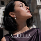 Alternate upward-looking model portrait wearing the same clear stud and irregular white drop.