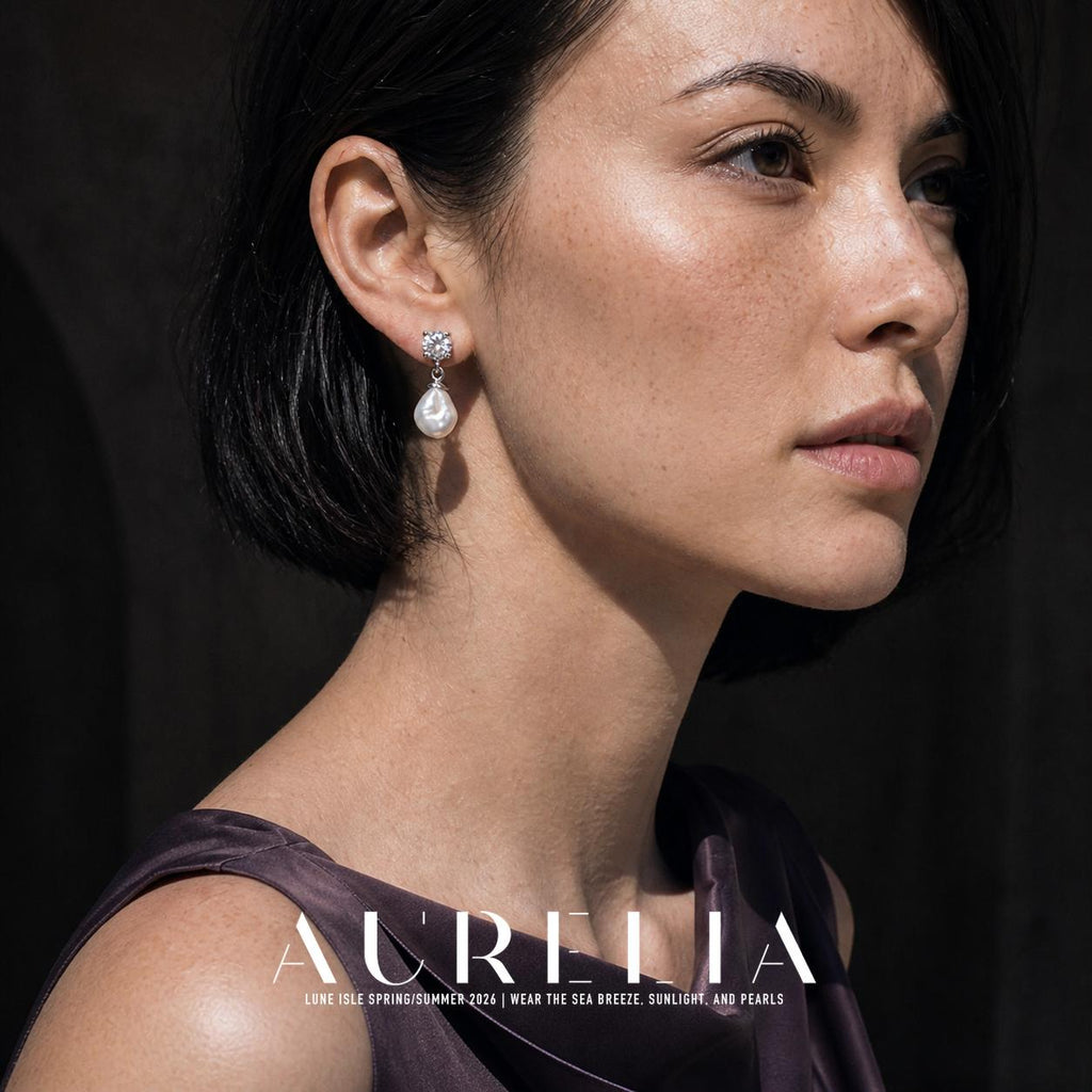 Close portrait showing the clear stud, ring connector and white drop against dark hair.