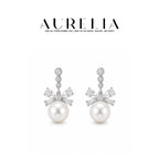 Triple Accent Bow Crystal Pearl Drop Earrings — supplied AURELIA product photograph.